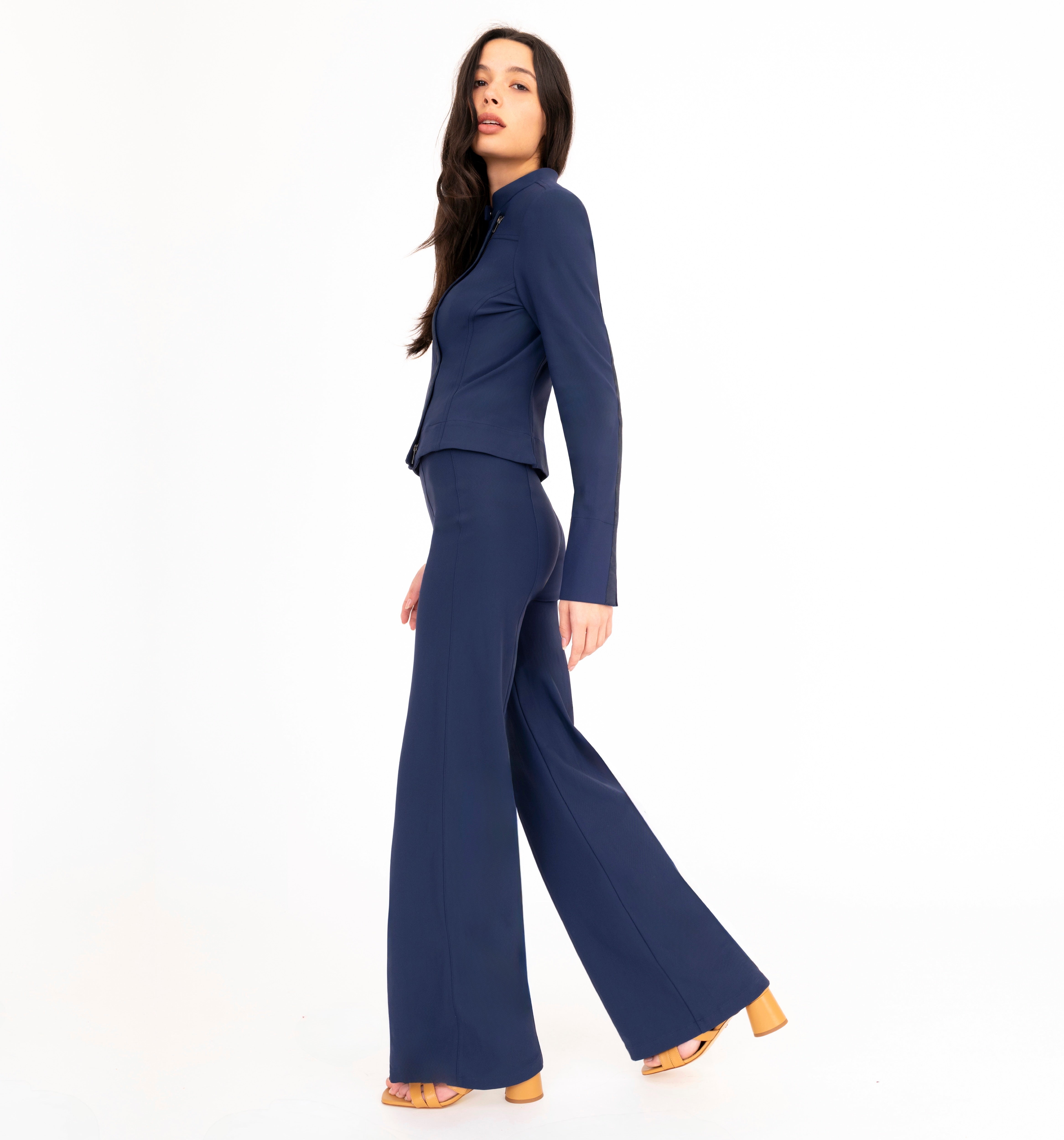 Woman wearing a navy blue outfit on a white background