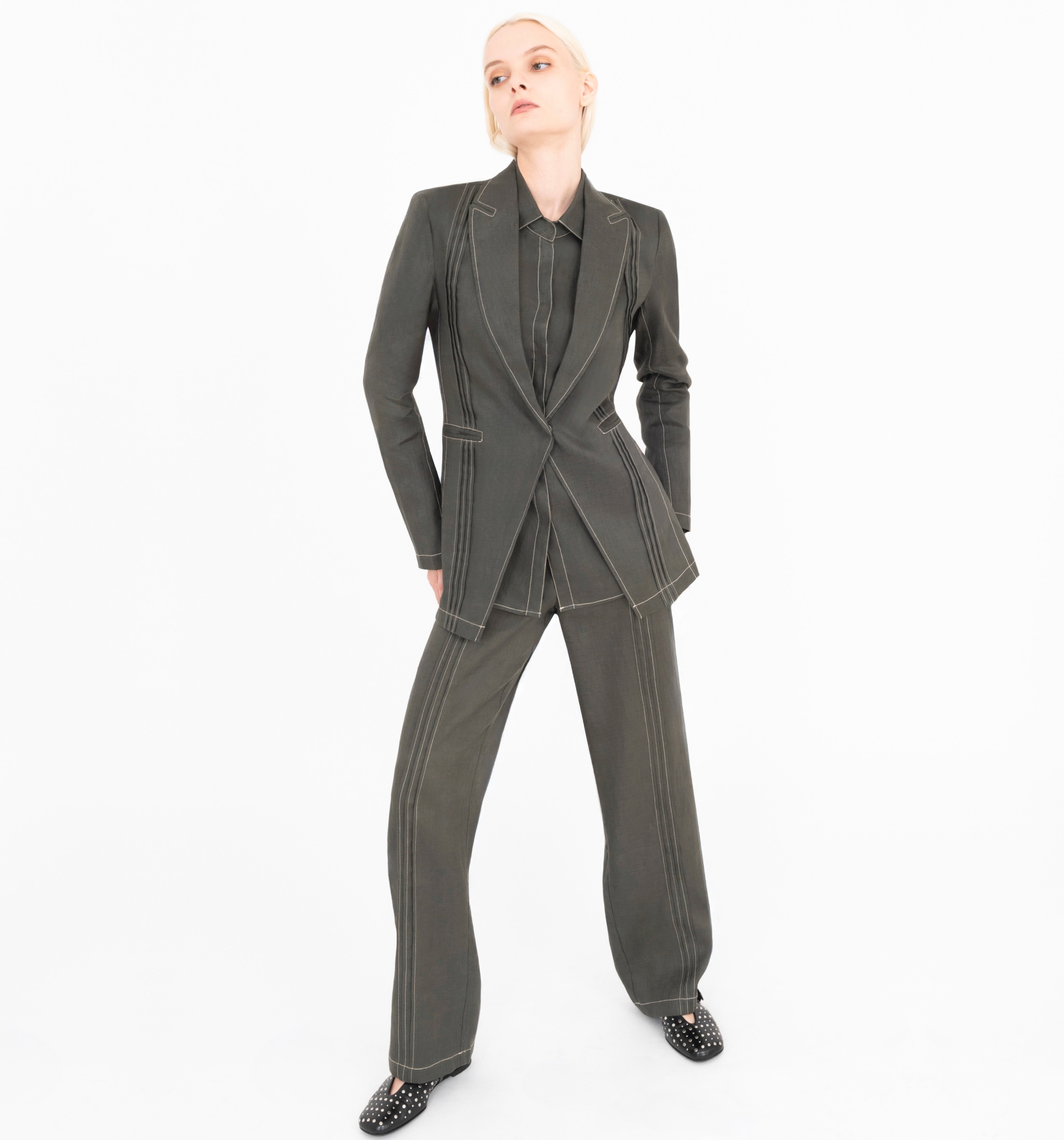 Woman wearing a green suit on a white background