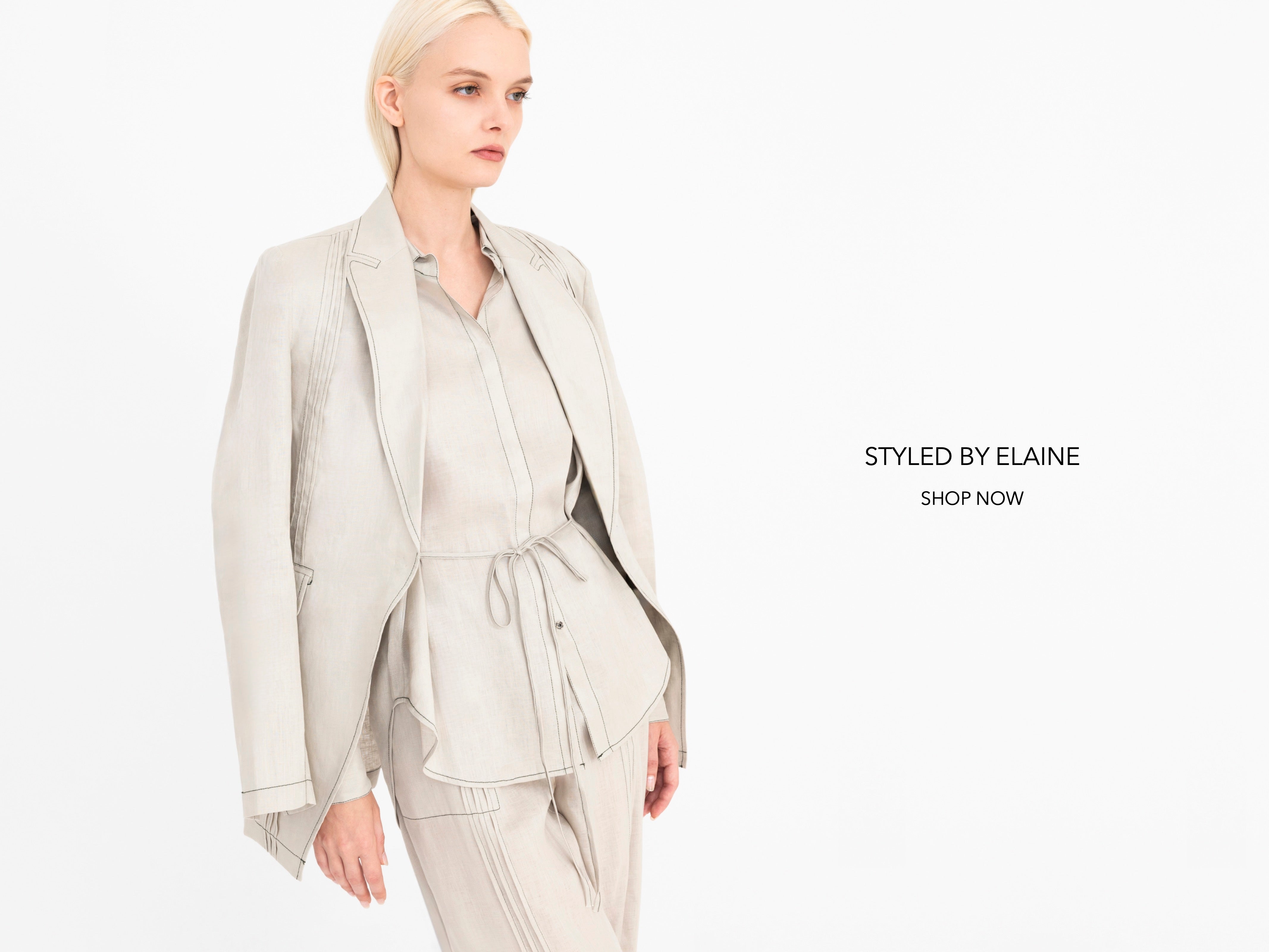 Woman wearing a light beige suit on a white background