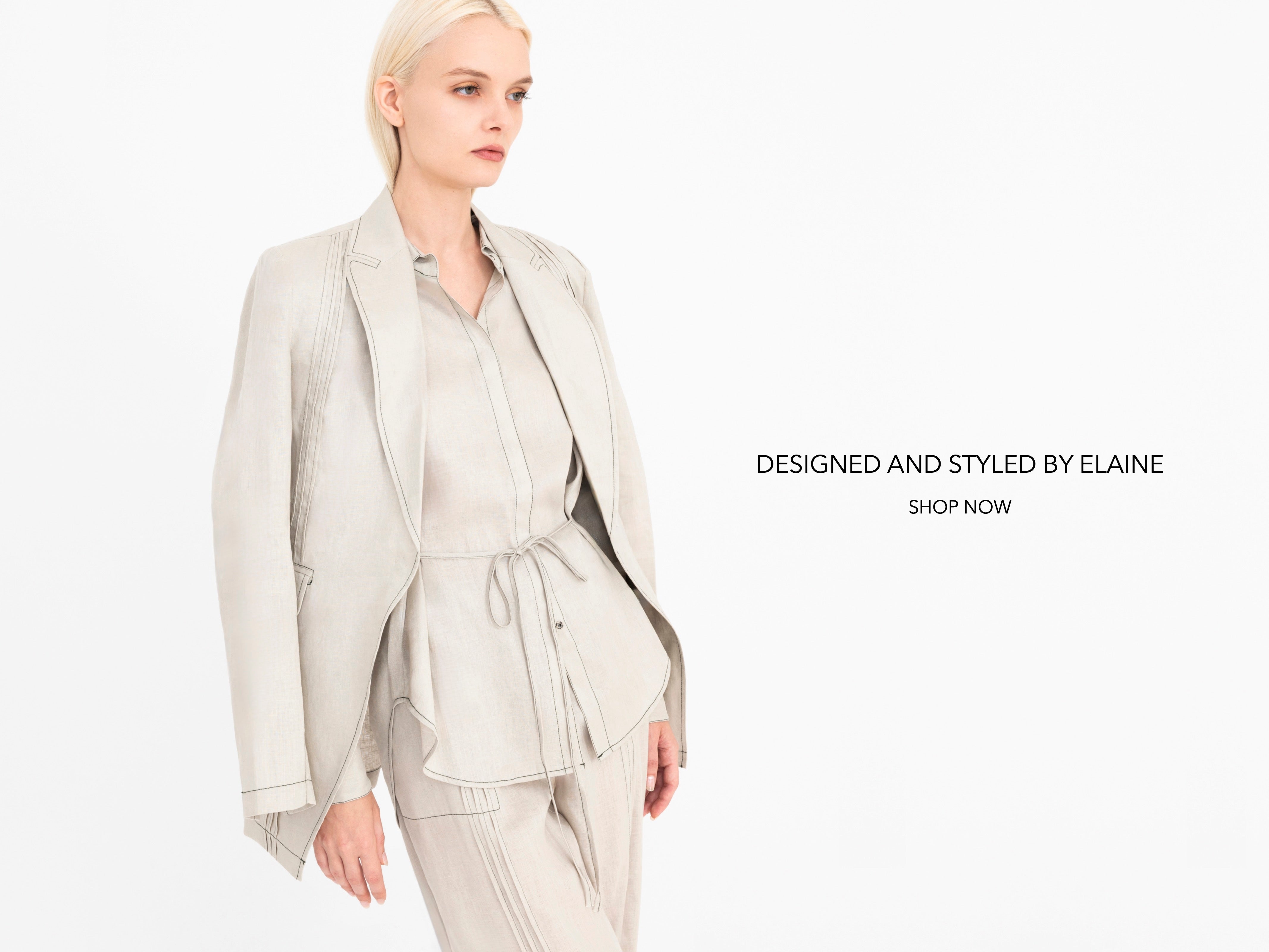Woman wearing a light beige suit on a white background