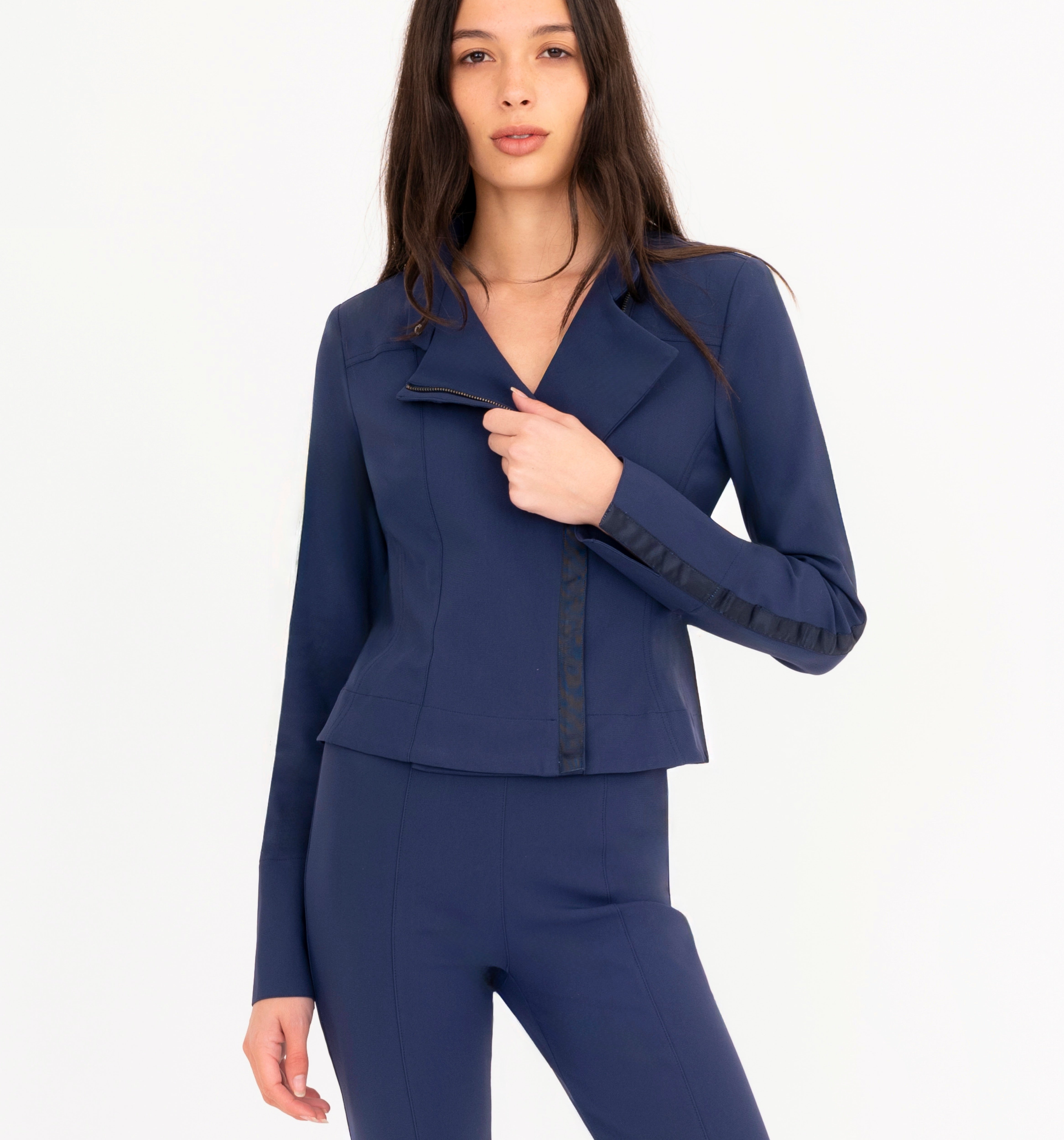 Woman wearing blue jacket and pants on a white background