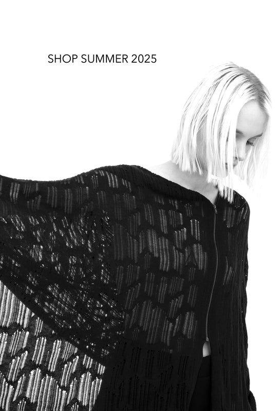 woman wearing black distressed knit poncho