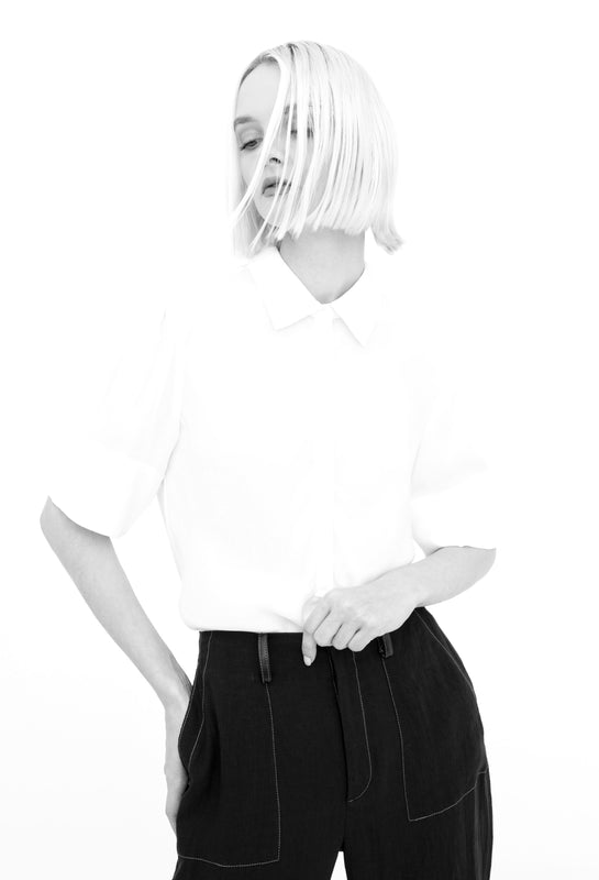 woman wearing white silk shirt and and black linen pants