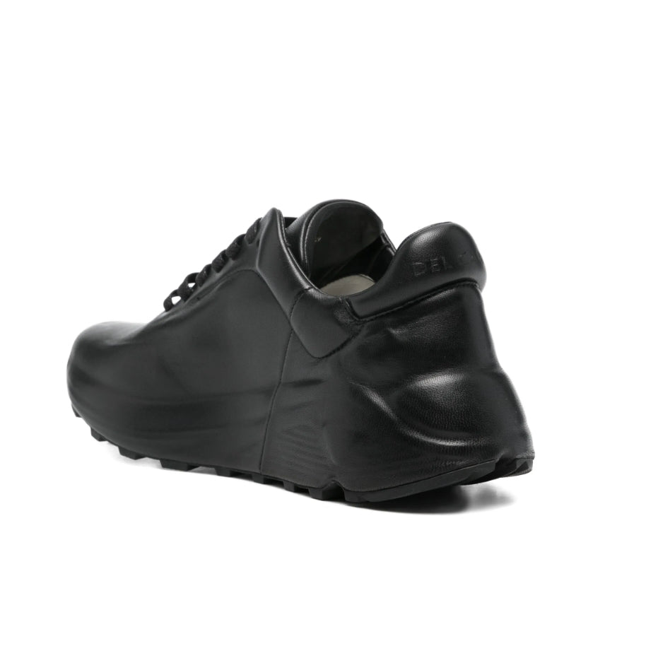 Black sneaker on a light gray background