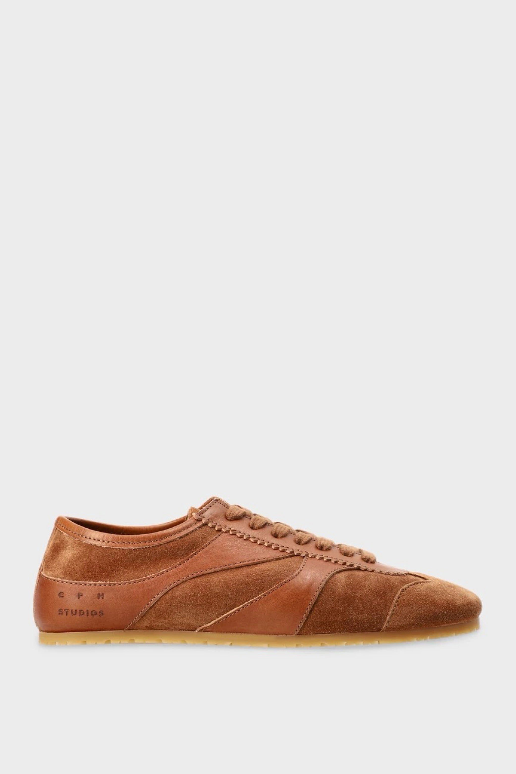 Brown suede sneaker on a light gray background