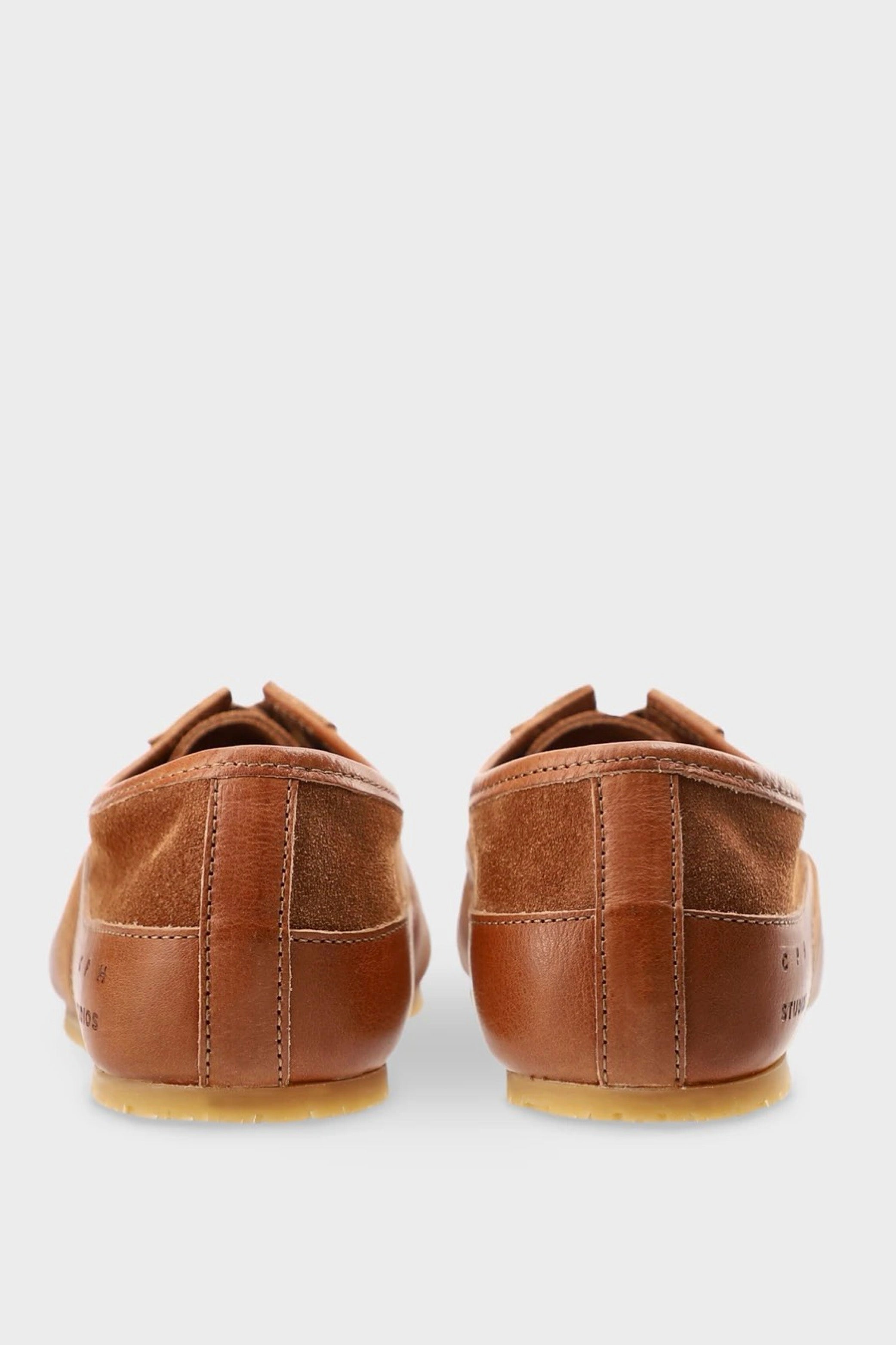 Brown suede shoes on a white background