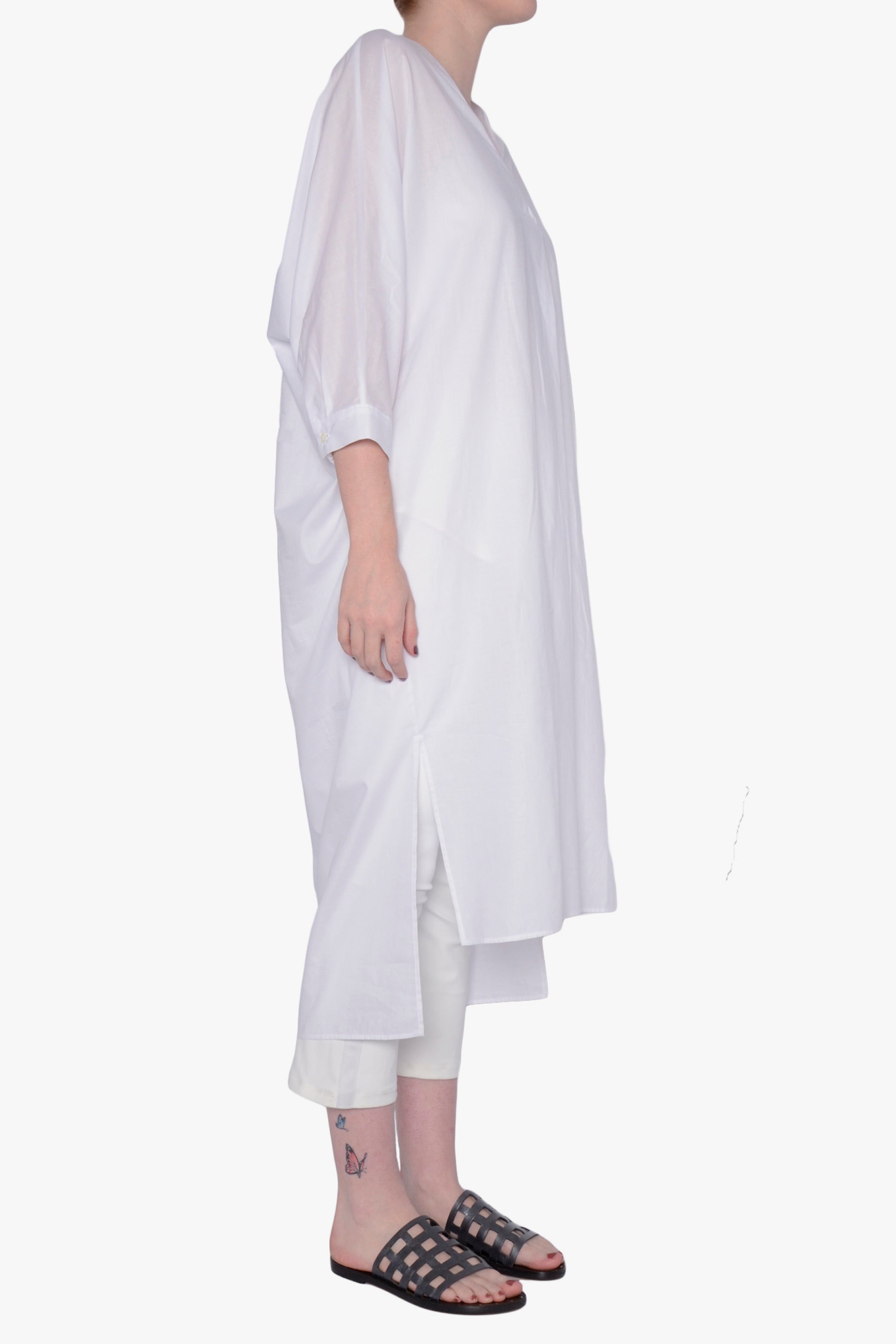 White long-sleeve dress against a white background