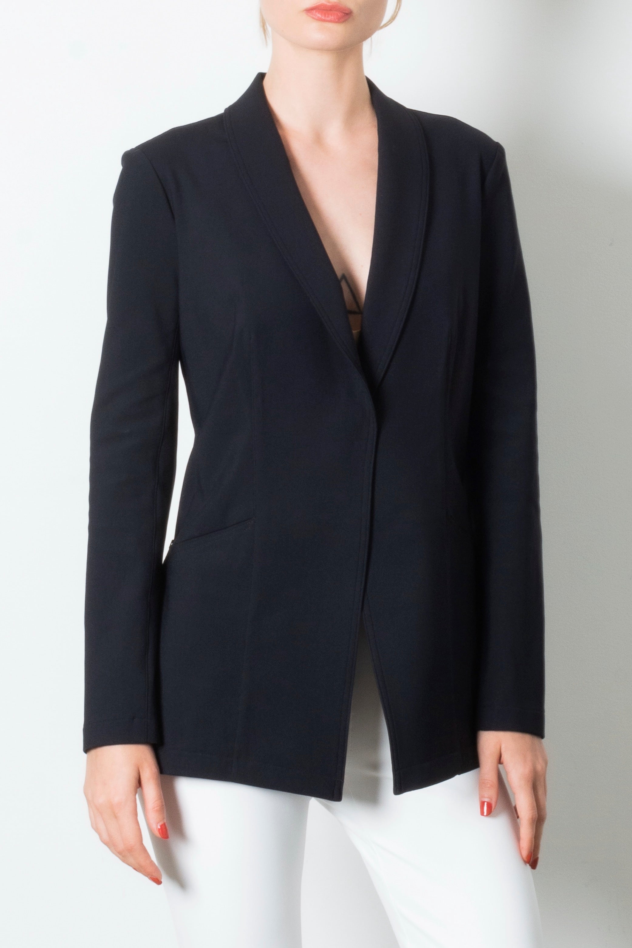 Black blazer worn by a person on a white background