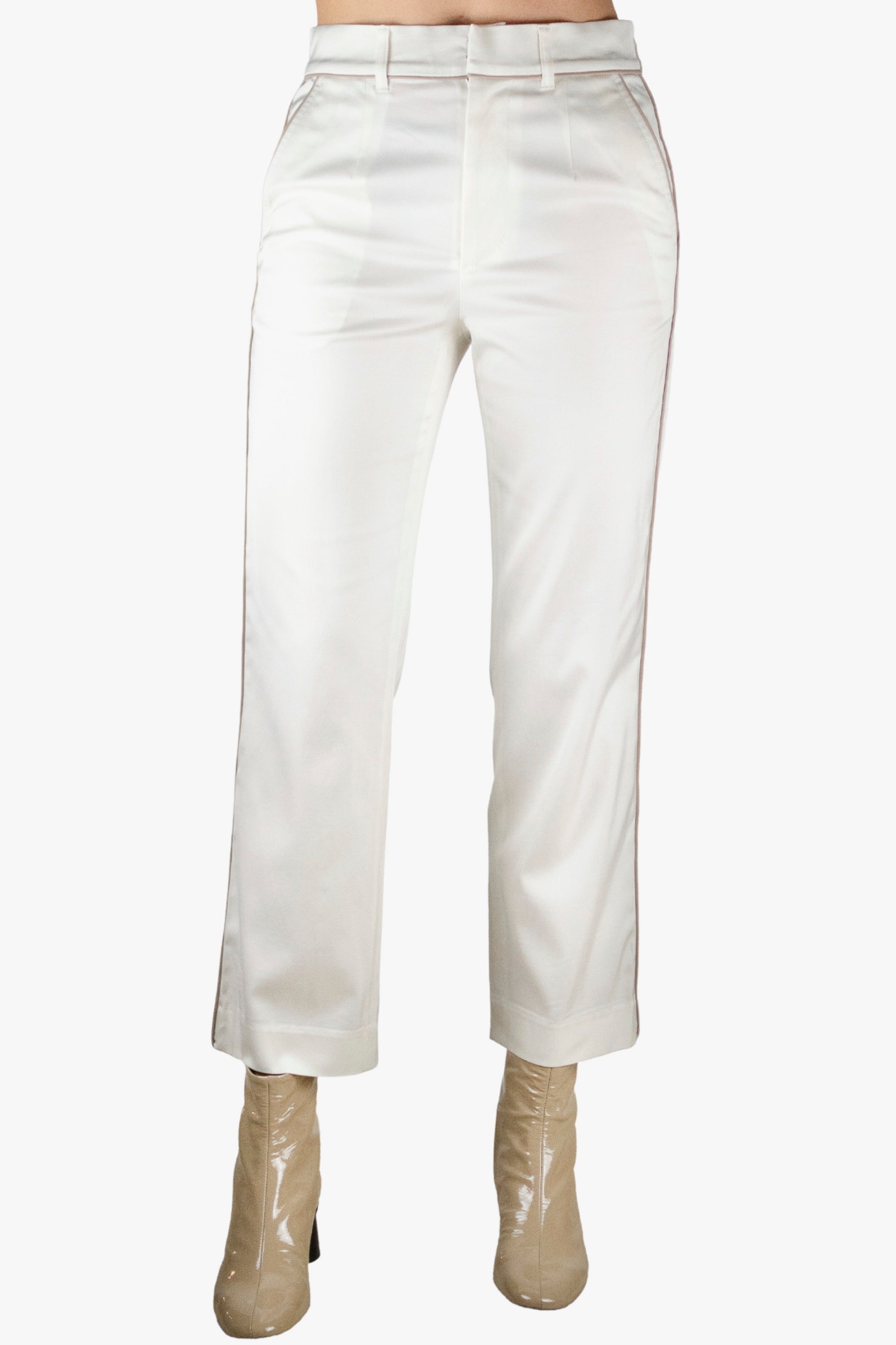 White pants worn by a person on a white background