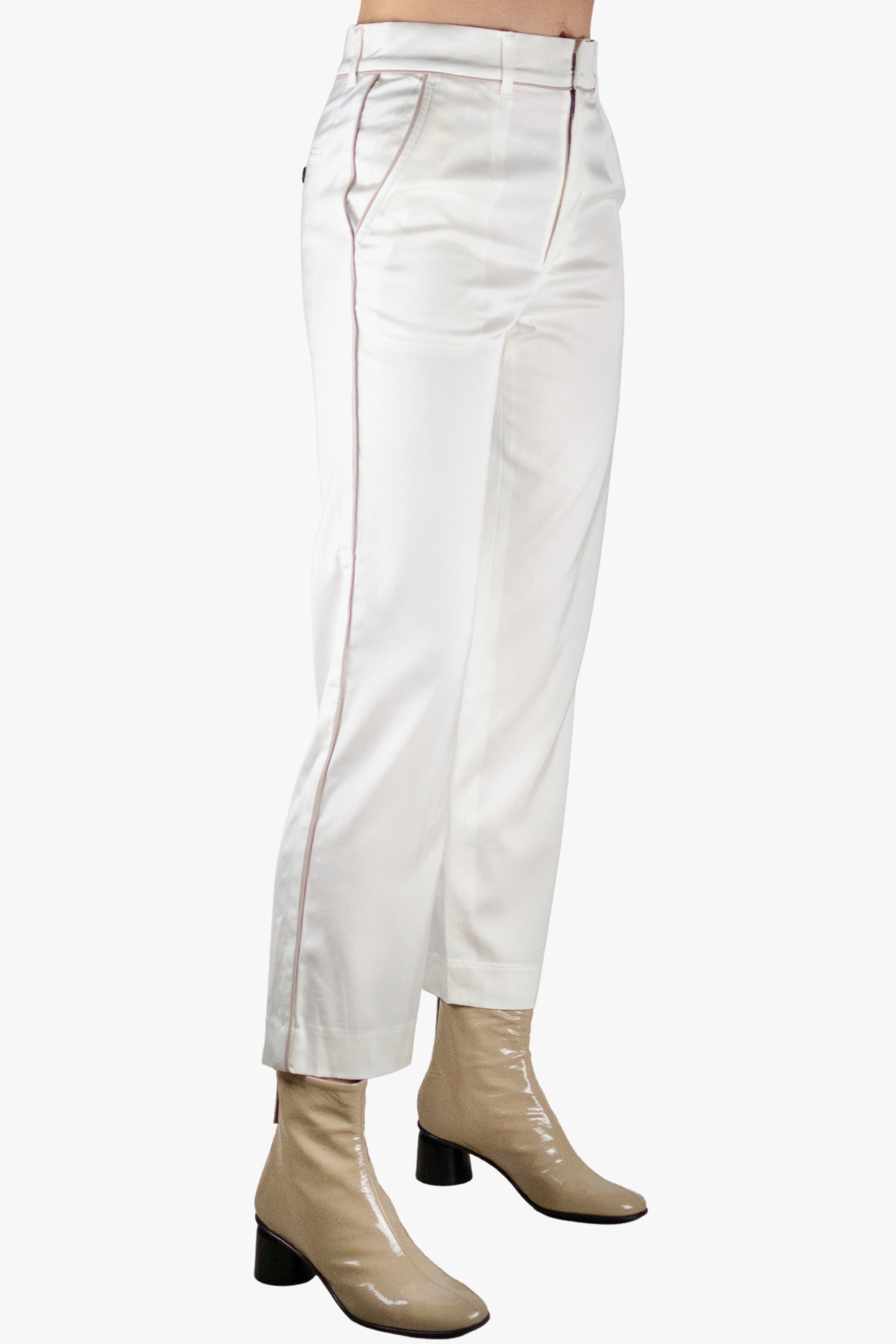 White pants worn by a person on a white background