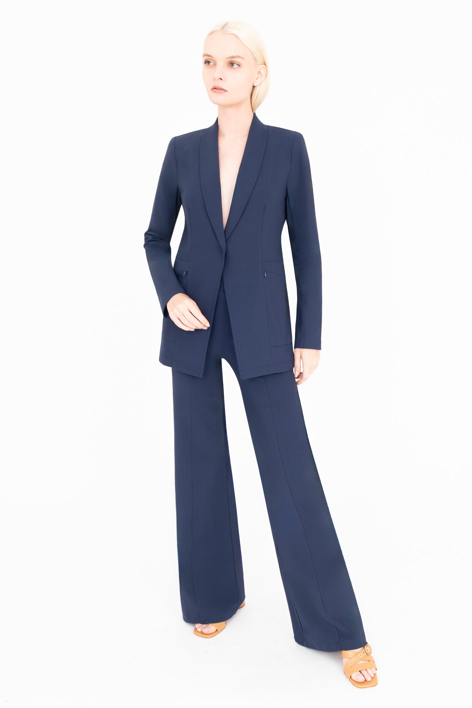 Woman wearing a navy blue suit on a white background