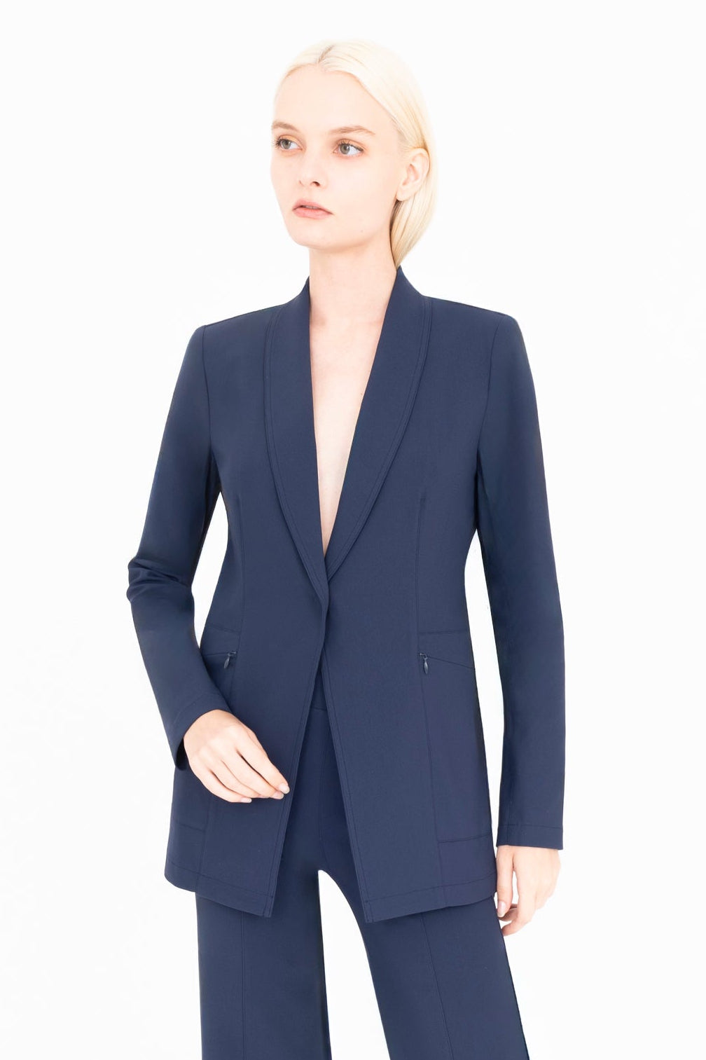 Woman wearing a navy blue suit on a white background