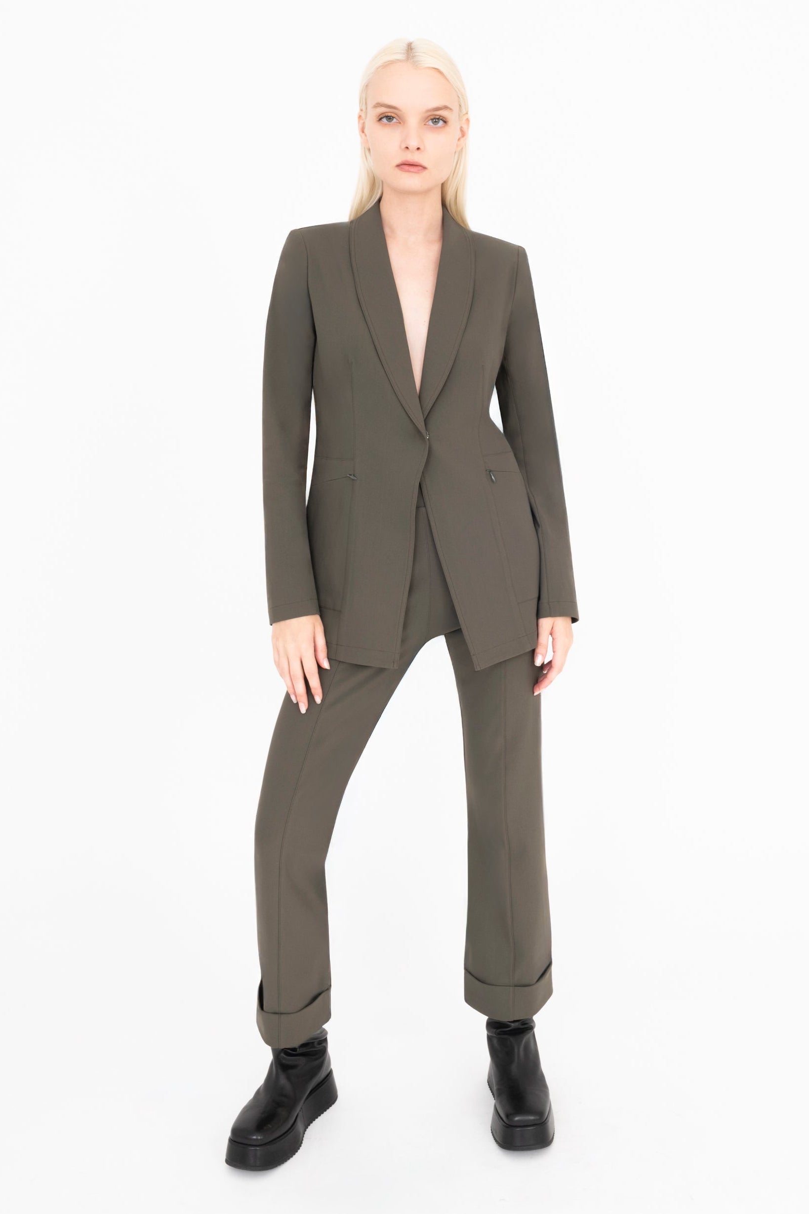 Woman wearing green suit on a white background