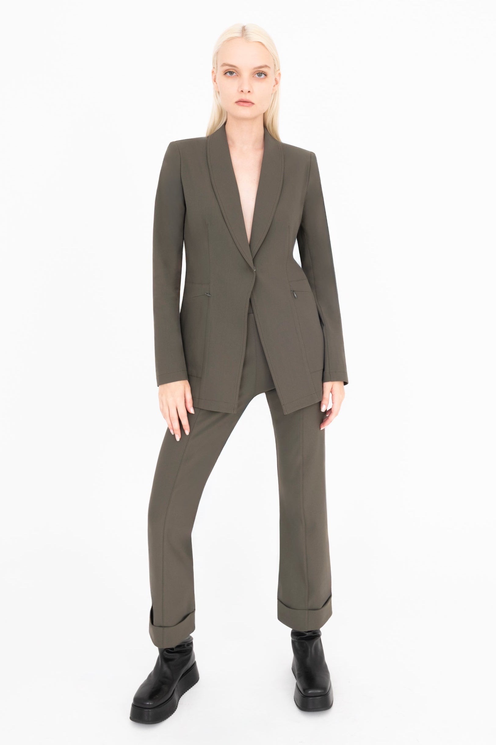 Woman wearing a green suit on a white background
