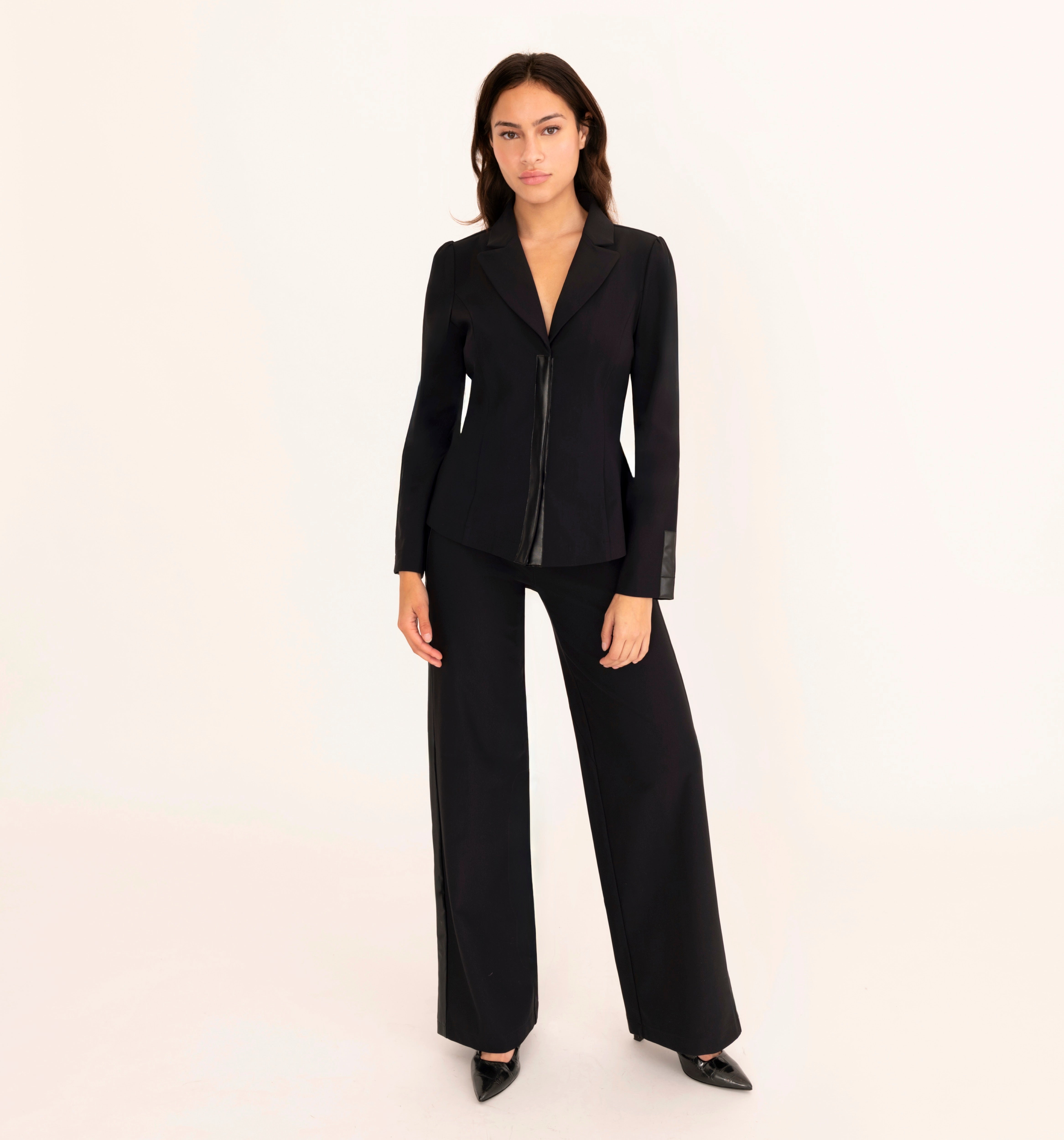 Woman wearing black suit on a white background